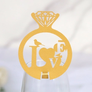 Close-up of gold glitter diamond ring wine glass card with heart and LOVE laser cut detail