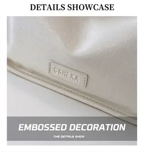 Detailed macro view of white pebble leather texture and C&HEKA brand logo plate