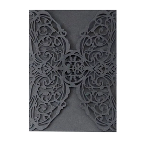 Detail view of laser-cut black Halloween wedding invitation card with baroque floral pattern