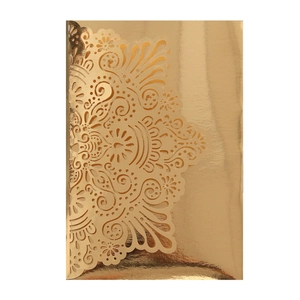 Macro detail of laser-cut lace pattern on metallic gold luxury wedding invitation card