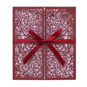Elegant laser cut red floral wedding invitation card with a luxurious silk ribbon bow