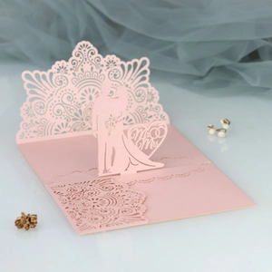 Detailed laser-cut mandala pattern and Mr & Mrs 3D silhouette on pink wedding invitation