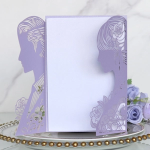 Detail view of purple laser cut wedding invitation with lace rose and couple silhouette