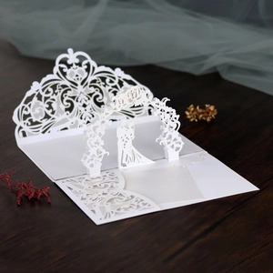 Macro detail of laser-cut 3D wedding invitation with bride and groom silhouette