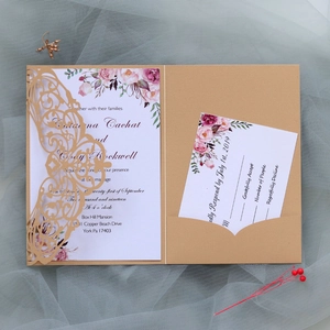 Detail of laser-cut wedding invitation with floral insert and RSVP card on mesh background
