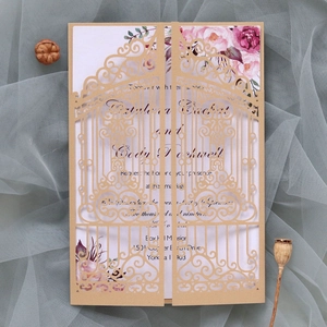Detail of laser-cut gate design on wedding invitation with floral printed card