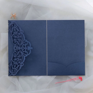 Detailed laser-cut lace pattern on a premium dark blue wedding invitation pocket cover