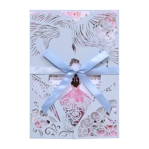 Laser-cut wedding invitation with blue floral lace design and a silk satin ribbon bow