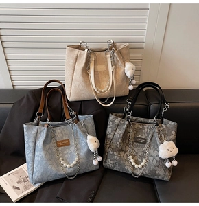 Detailed view of floral tote bags with metal chains, pearls and cloud charms in three colors
