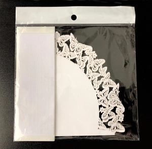 Detailed laser-cut white butterfly paper confetti cones for wedding petals in packaging