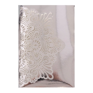 Macro shot of silver laser-cut mandala lace pattern on an elegant wedding invitation