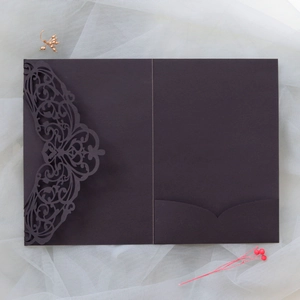 Close-up of laser-cut hollow pattern on luxury pearlescent paper wedding invitation