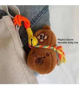 Détail d'un porte-bonheur en peluche brodé sur un sac seau en toile blanche