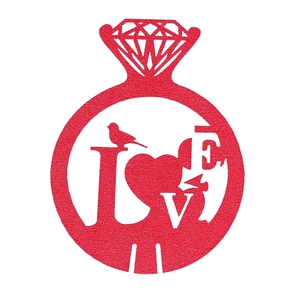 Detailed view of red laser-cut LOVE engagement ring paper decoration for wedding wine glasses