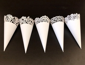 Set of 5 laser-cut white wedding paper cones featuring intricate floral and lace patterns