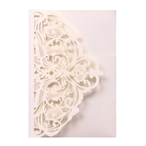 Detail of laser-cut damascus floral patterns on ivory pearlescent paper invitation