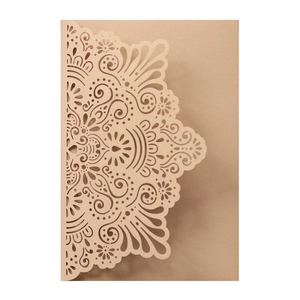 Detail of laser-cut mandala pattern on champagne pearlescent engagement invitation