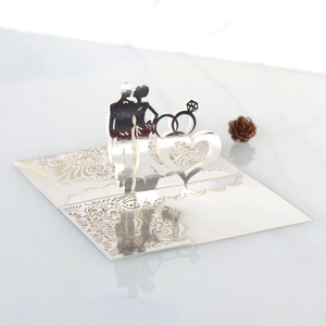 Detailed laser-cut silver 3D wedding card featuring heart and diamond ring motifs