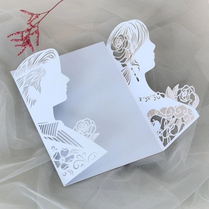Detailed laser cut lace wedding invitation featuring romantic couple silhouette and roses