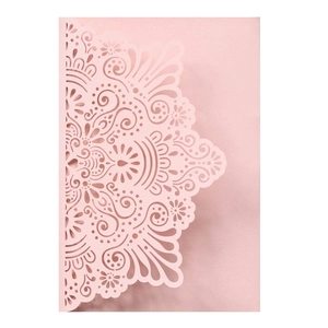 Detailed laser-cut pattern on pink pearlescent paper for wedding invitations