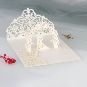 Exquisite 3D laser-cut wedding invitation featuring an elegant couple kissing under an archway