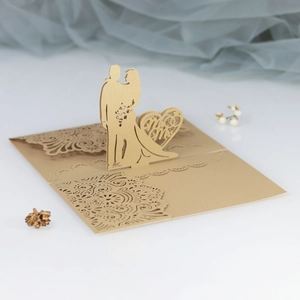 Laser cut 3D wedding card featuring hollow Mr & Mrs silhouette in gold pearl paper