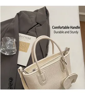 Detail of lychee pattern handbag with elegant round handles and small horse charm accessory