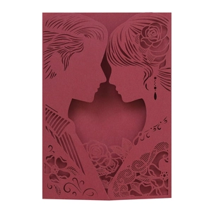 Detailed laser-cut wedding invitation featuring bride groom silhouette and rose patterns