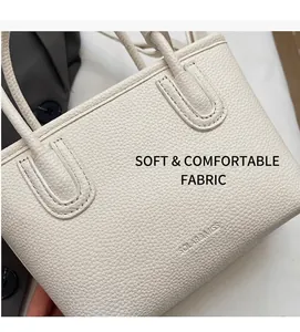 Detail of white lychee pattern leather bucket bag with fine stitching and soft texture