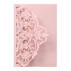 Close-up of pink laser-cut floral filigree invitation cover with pearlescent finish