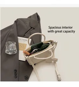 Internal capacity of white lychee leather bucket bag holding smartphones and makeup