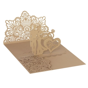 Detailed laser-cut gold wedding invitation with Mr & Mrs silhouette and intricate lace pattern
