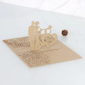Detailed laser cut champagne gold wedding invitation with Mr & Mrs silhouette design