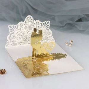 Detailed macro view of laser-cut 3D wedding card with gold foil Mr & Mrs lettering