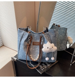 Detail of floral tote bag with leather handles, pearl chains, and cloud charm in a mirror setup