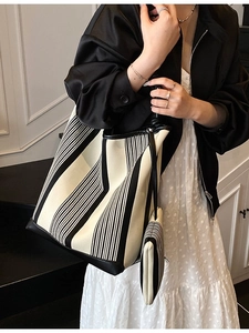 Large black and white striped tote bag with matching zipper pouch for daily commuting