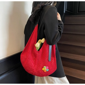Close-up of red crochet hobo bag featuring floral embroidery and large capacity space