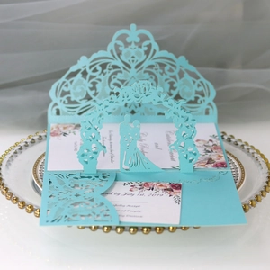 Detail of 3D pop-up wedding invitation with laser-cut floral patterns and blue cover