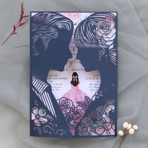 Close-up of laser-cut wedding invitation featuring rose patterns and couple silhouette