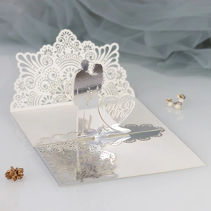Detailed laser-cut hollow lace wedding invitation featuring Mr & Mrs silhouettes
