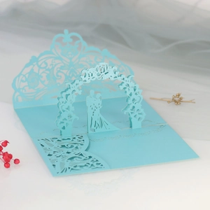 Detail of 3D laser cut light blue wedding invitation with intricate floral patterns
