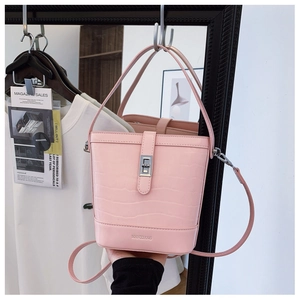 Detailed macro of pink bucket bag with crocodile texture and silver twist lock closure