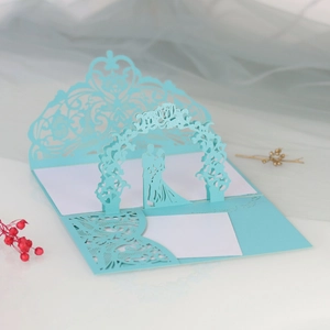 Detailed laser-cut wedding invitation featuring 3D silhouette of a couple in light blue