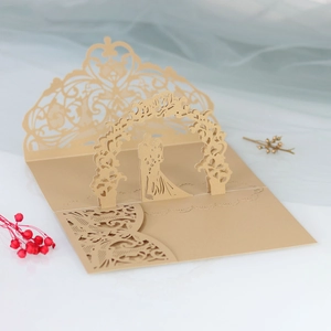 Detailed laser-cut 3D pop-up wedding invitation in champagne gold with bride and groom silhouette