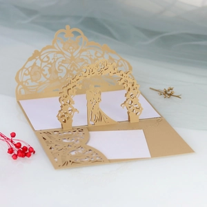 Macro detail of champagne gold laser-cut wedding invitation with 3D floral arch design