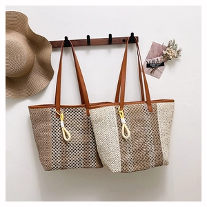 Detail of hand woven beach tote with brown leather straps and decorative knot tassel