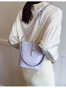 Lavender crocodile embossed bucket bag with silver twist lock and adjustable shoulder strap