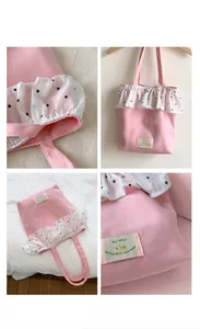 Detail of pink canvas tote bag showing floral ruffle trim and green woven label
