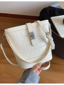 White crocodile pattern bucket handbag with silver metal lock and thin shoulder strap