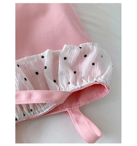 Close-up of pink canvas tote bag showing floral ruffle trim and stitching details